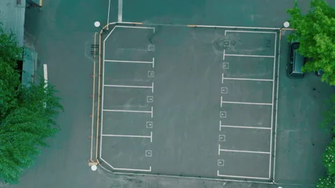 Top shot empty parking lot. dry asphalt sunny day. white line markings Stock Footage 154965305