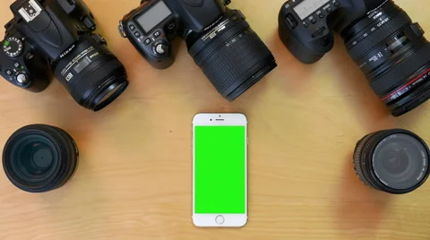 Top shot of green screen iphone with various digital cameras and lens background Stock Footage 67469198