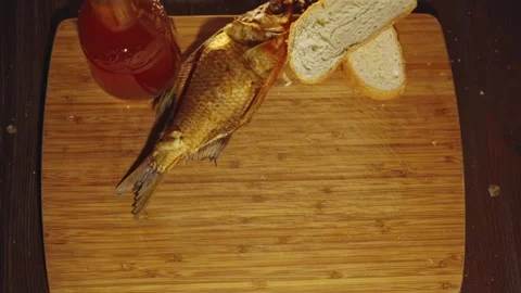 Top shot hand hits the table with dry fish beer snack, ex soviet USSR tradition Stock Footage 279230687
