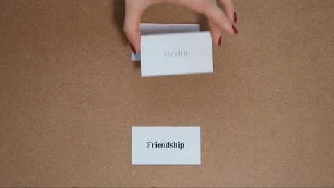 Top shot - Hand puts paper card HEALTH. CORE VALUE concept. Vidéo 124576252