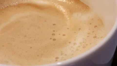 Top shot of hot coffee with bubbles on table inside restaurant Video stock 96580129