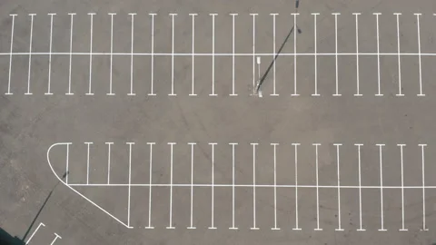 Top shot large empty parking lot. dry asphalt sunny day. white line markings Stock Footage 154873126