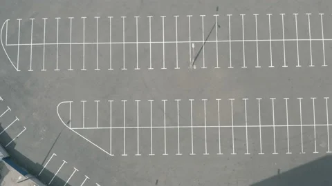 Top shot large empty parking lot. dry asphalt sunny day. white line markings Stock Footage 154873398