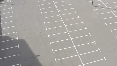 Top shot large empty parking lot. dry asphalt sunny day. white line markings Stock Footage 154873632