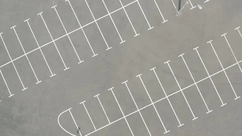 Top shot large empty parking lot. dry asphalt sunny day. white line markings Stock Footage 154883554
