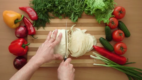 Top shot of man chef cutting cabbage on chopping wooden board Stock Footage 87788840
