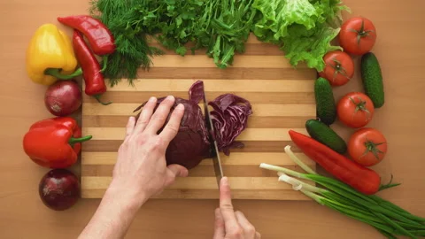 Top shot of man chef cutting cabbage on chopping wooden board Stock Footage 87803817