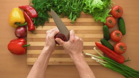 Top shot of man chef cutting bow on chopping wooden board Stock Footage 87804936