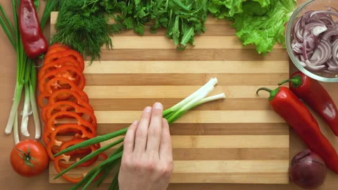 Top shot of man chef cutting greens on chopping wooden board Stock Footage 87808008