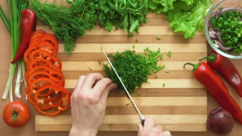 Top shot of man chef cutting greens on chopping wooden board Stock Footage 87808365