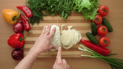 Top shot of man chef cutting cabbage on chopping wooden board Stock Footage 87901311
