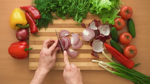 Top shot of man chef cutting bow on chopping wooden board Stock Footage 87902087