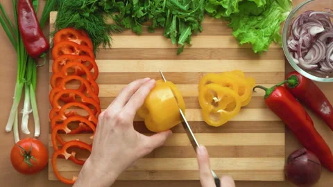 Top shot of man chef cutting bell pepper on chopping wooden board Stock Footage 87904000