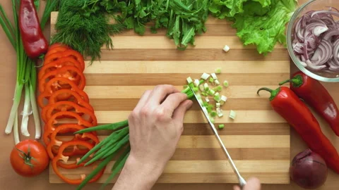 Top shot of man chef cutting greens on chopping wooden board Stock Footage 87904586