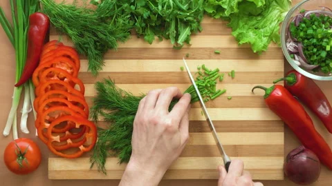 Top shot of man chef cutting greens on chopping wooden board Stock Footage 87905057