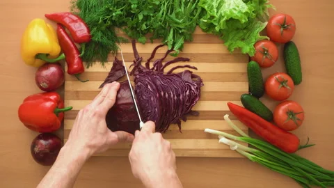 Top shot of man chef cutting cabbage on chopping wooden board Stock Footage 87981719
