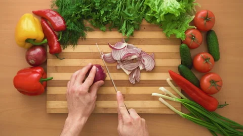 Top shot of man chef cutting bow on chopping wooden board Stock Footage 87985856
