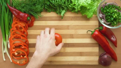 Top shot of man chef cutting tomatoes on chopping wooden board Stock Footage 88004473