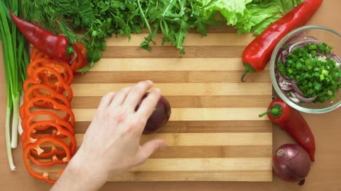 Top shot of man chef cutting bow on chopping wooden board Stock Footage 88006873
