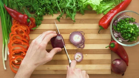 Top shot of man chef cutting bow on chopping wooden board Stock Footage 88175866