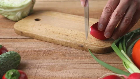Top shot of man chef cutting radish on chopping board Video stock 89775178