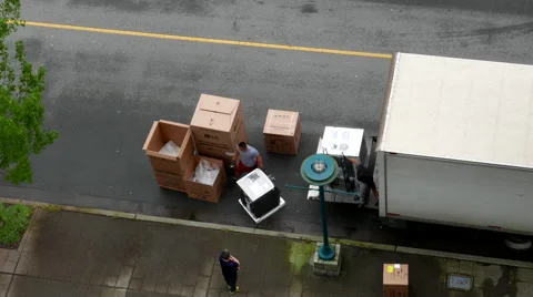 Top shot of movers unloading electric home appliances Stock Footage 62748354