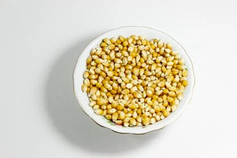 Top shot of multiple corn seeds in the small white cup Stock Photos