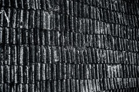 Top shot of the old-styled rectangular-shaped rooftop tiles fixed on a roof o Stock Photos