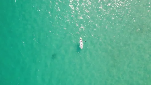 Top shot of one white paddle board in crystal clear turquoise sea Stock Footage 159227647