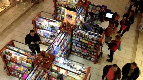 Top shot of shopper inside Coquitlam shopping mall at selling books booth Stock Footage 54262179