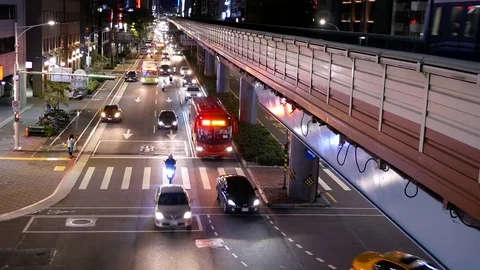 Top shot of skytrain passing by building and heavy traffic flow Stock Footage 82766279