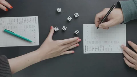 Top shot of two friends playing yahtzee Stock Footage 141989279