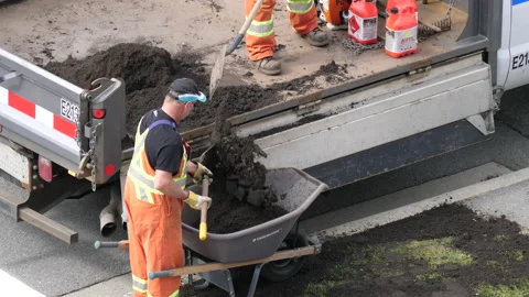 Top shot of worker pouring waste soil on truck with 4k resolution Stock Footage 105848694