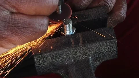 Top Side View Cutting A Metal Bolt With Dremel Tool Stock Footage 219128937