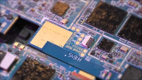 Top side view of microchips spent and melted close up blurred background Stock Footage 270453067