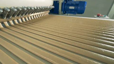 Top side-view of parallel lines of paste flowing from a paste-making machine Stock Footage 85922879