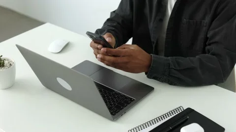 Top side view shot african american man hands hold cellphone typing and chatting Stock Footage 196127264