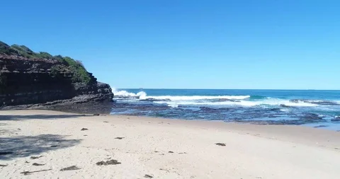 Top Sown Drone Shot Waves Crushing against the rocks Video stock 115697007