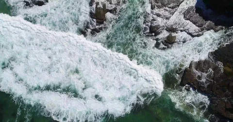 Top Sown Drone Shot Waves Crushing against the rocks Video stock 115761055