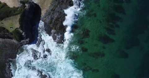 Top Sown Drone Shot Waves Crushing against the rocks Video stock 115762611