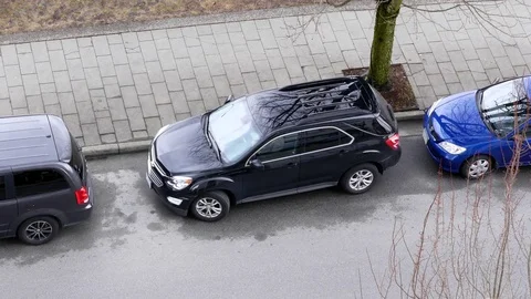 Top sTop shot of car leaving parallel parking site on the road Stock Footage 73104825