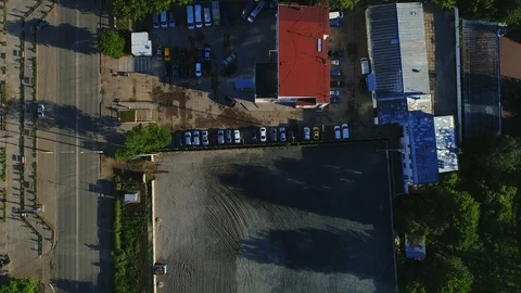 Top straight down view of new car lot, many vehicles for sale, glistening in the Stock Footage 110305305