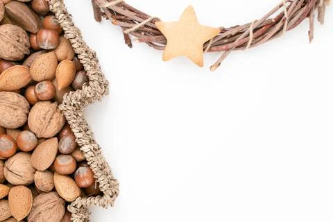 Top studio shot of basket full of mixed nuts and dry handmade Christmas wreath Stock Photos
