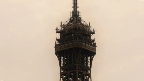 Top Summit of Eiffel Tower in City of Paris on Cloudy Day, Tilt Up View Stock Footage 242015690