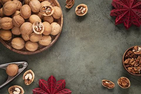 Top table view Christmas background with walnuts in shell on wooden tray. Stock Photos