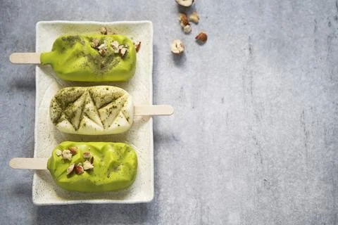 Top table view on three delicious vanilla and matcha ice cream bars. Stock Photos