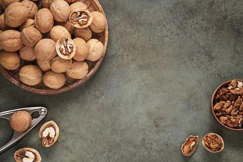 Top table view with walnuts in shell on wooden tray. Stock Photos