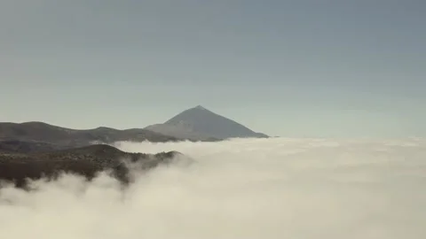 The top of the Teide volcano rises above a thick layer of white clouds Stock Footage 133069612