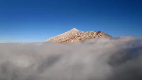 The top of the Teide volcano rises above a thick layer of white clouds. Stock Footage 146853834