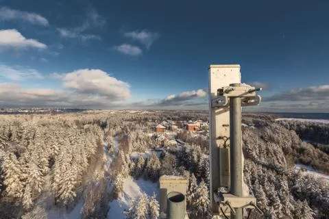 Top of telecommunication tower with vertical panel antennas and remote radio Stock Photos